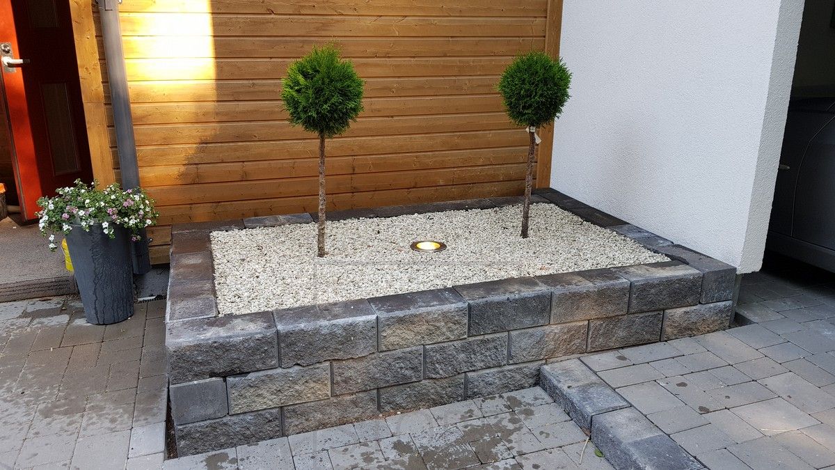 LED LAND LIGHT installed in a flower bed to illuminate plantings and facade.